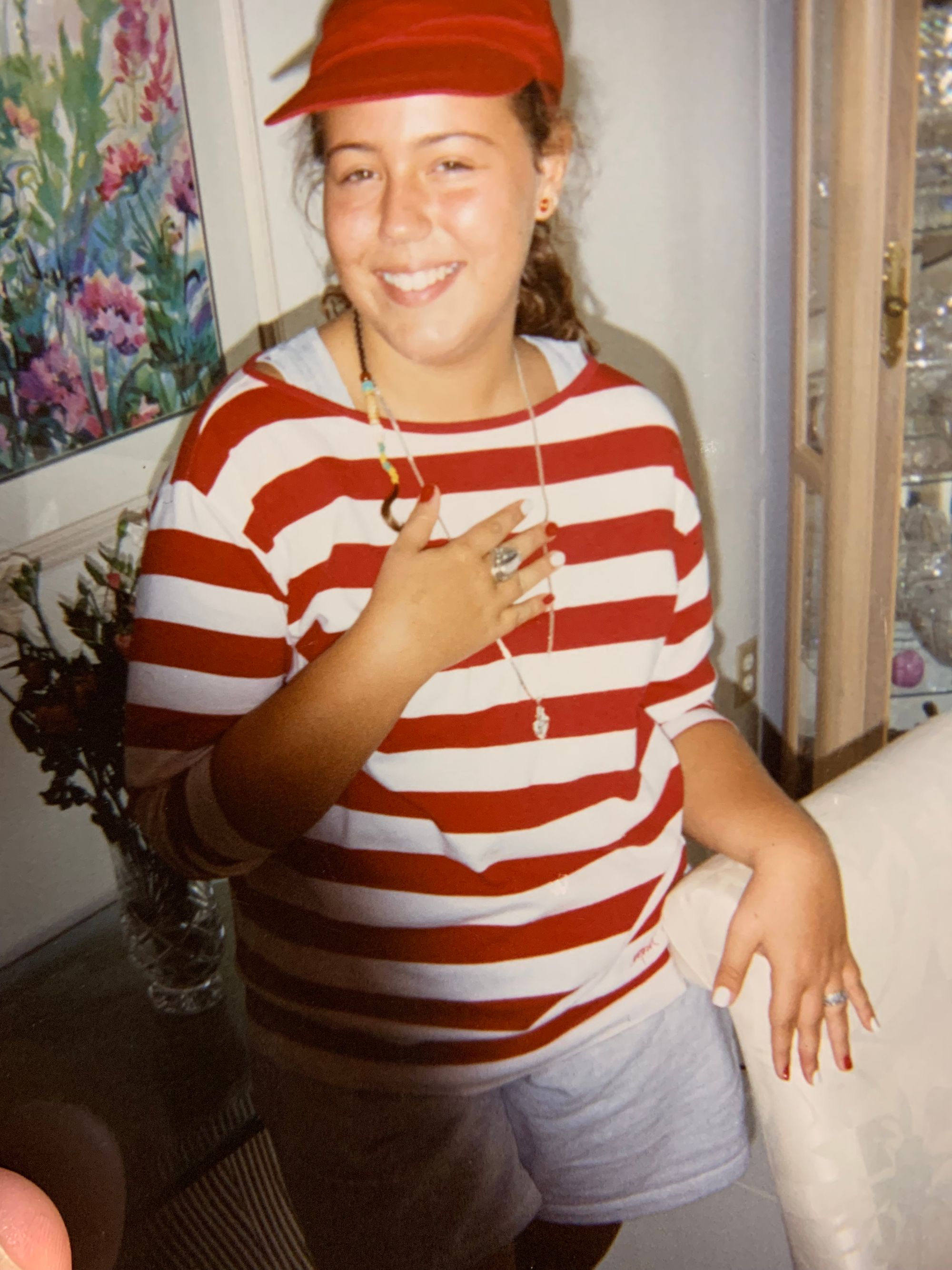 a white feminine person wearing red and white, even down to fingernails, for a school event at coral gables high school in miami, florida.