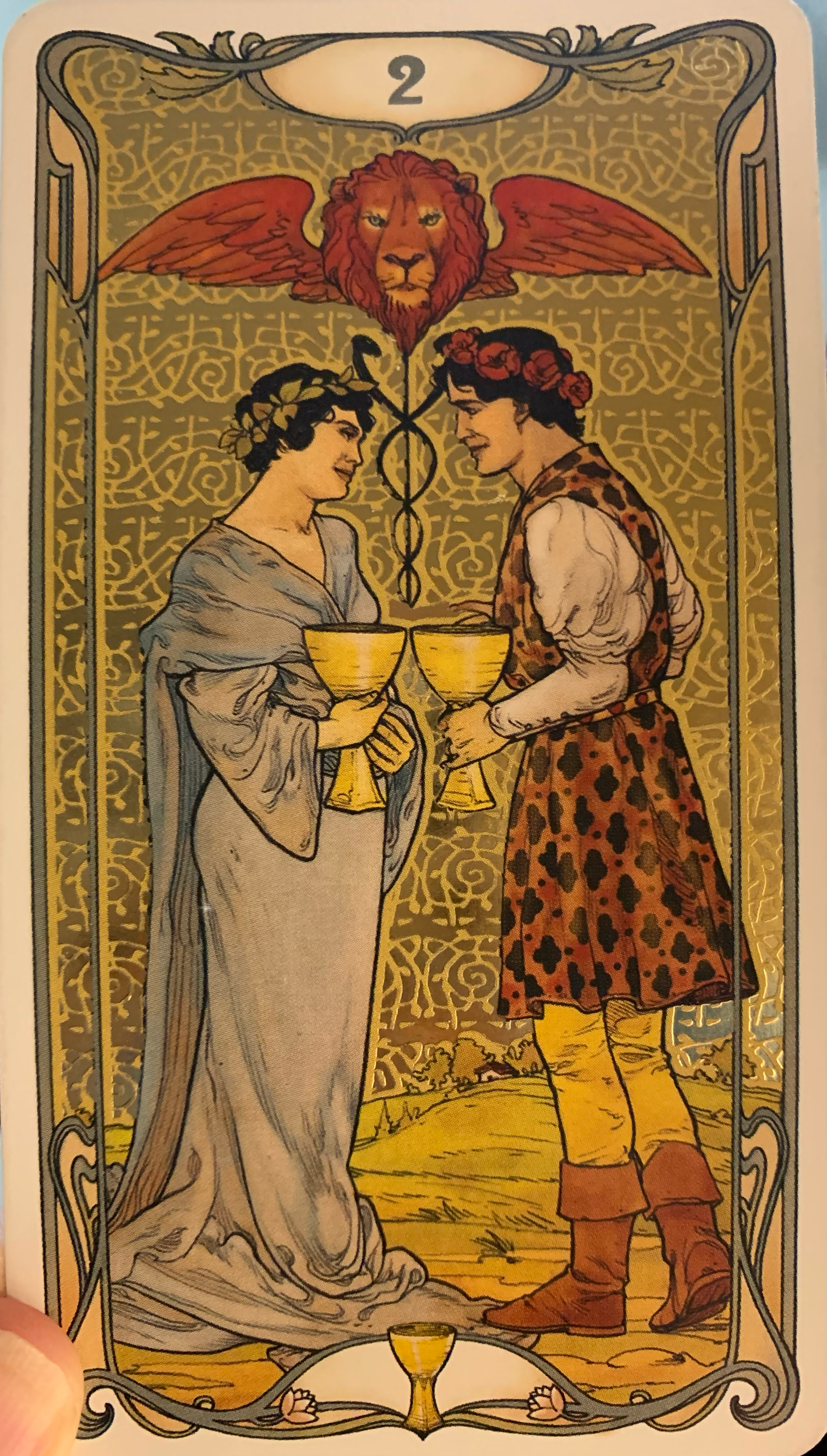 The two of cups from a tarot deck called Golden Art Nouveau.