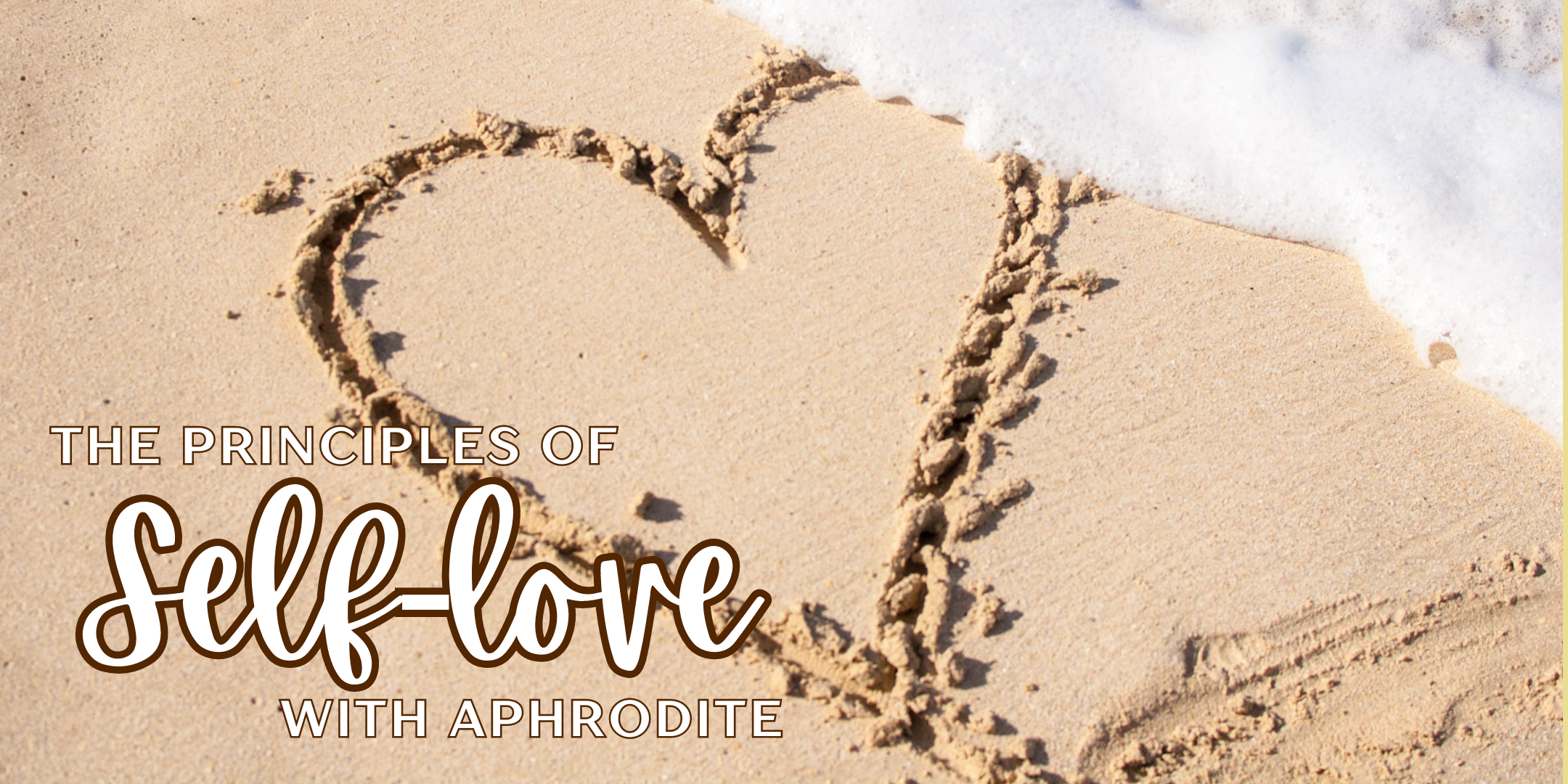 A heart written in the sand with the words "the principles of self-love with Aphrodite" in white.